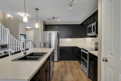 23 Copperpond Square Se, Calgary, AB - Indoor Photo Showing Kitchen With Stainless Steel Kitchen With Double Sink With Upgraded Kitchen