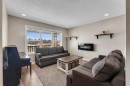 23 Copperpond Square Se, Calgary, AB  - Indoor Photo Showing Living Room With Fireplace 