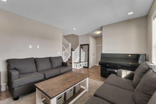 23 Copperpond Square Se, Calgary, AB - Indoor Photo Showing Living Room