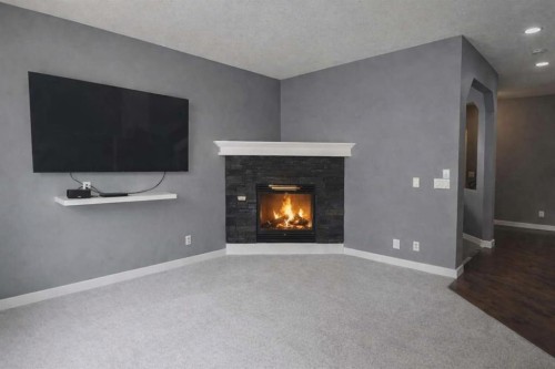 1580 New Brighton Drive Se, Calgary, AB - Indoor Photo Showing Living Room With Fireplace