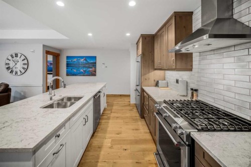 103-905 Spring Creek Drive, Canmore, AB - Indoor Photo Showing Kitchen With Double Sink With Upgraded Kitchen