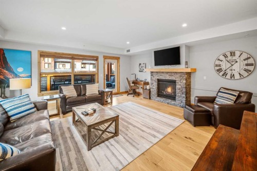 103-905 Spring Creek Drive, Canmore, AB - Indoor Photo Showing Living Room With Fireplace