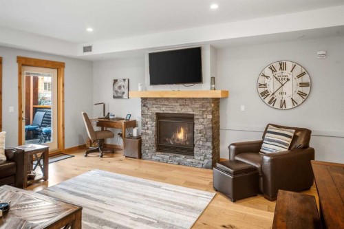 103-905 Spring Creek Drive, Canmore, AB - Indoor Photo Showing Living Room With Fireplace