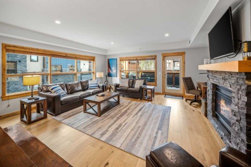 103-905 Spring Creek Drive, Canmore, AB - Indoor Photo Showing Living Room With Fireplace
