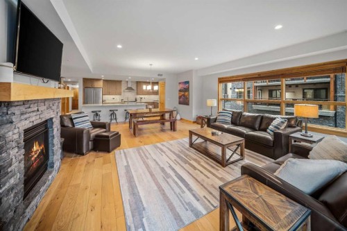 103-905 Spring Creek Drive, Canmore, AB - Indoor Photo Showing Living Room With Fireplace