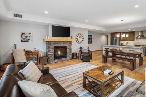 103-905 Spring Creek Drive, Canmore, AB - Indoor Photo Showing Living Room With Fireplace