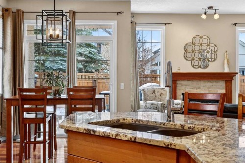 51 Cranleigh Gardens Se, Calgary, AB - Indoor Photo Showing Dining Room With Fireplace