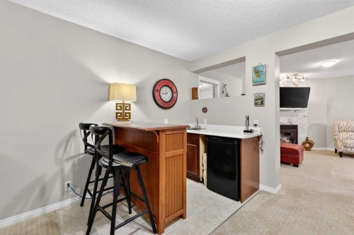 51 Cranleigh Gardens Se, Calgary, AB - Indoor Photo Showing Other Room With Fireplace