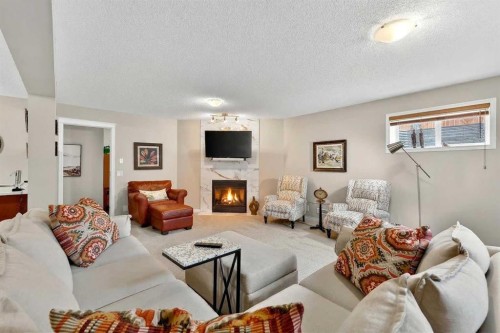 51 Cranleigh Gardens Se, Calgary, AB - Indoor Photo Showing Living Room With Fireplace