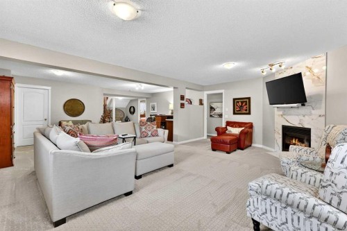 51 Cranleigh Gardens Se, Calgary, AB - Indoor Photo Showing Living Room With Fireplace