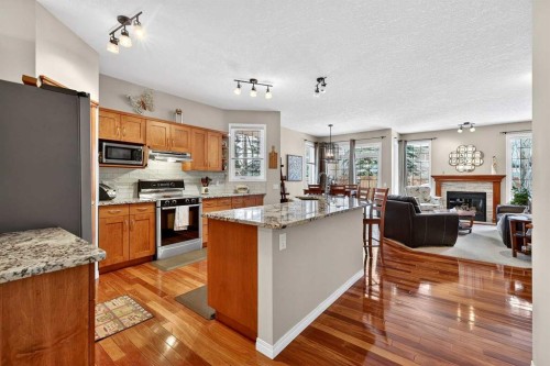 51 Cranleigh Gardens Se, Calgary, AB - Indoor Photo Showing Kitchen With Fireplace