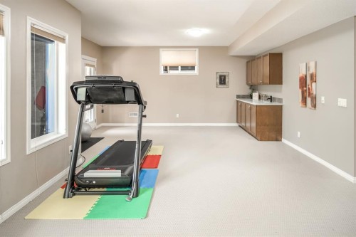 105 Aspen Stone Road Sw, Calgary, AB - Indoor Photo Showing Gym Room