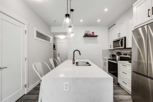 102-500 Auburn Meadows Common Se, Calgary, AB - Indoor Photo Showing Kitchen With Stainless Steel Kitchen With Double Sink With Upgraded Kitchen