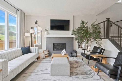 36 Cranbrook Cape Se, Calgary, AB - Indoor Photo Showing Living Room With Fireplace