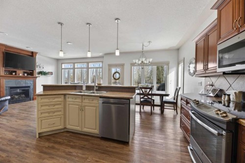 5910 Park Meadows Crescent, Olds, AB - Indoor Photo Showing Kitchen With Fireplace With Double Sink With Upgraded Kitchen