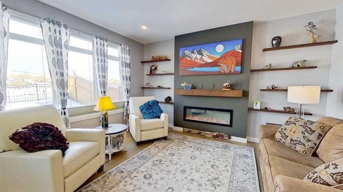 163 Sundown Crescent, Cochrane, AB - Indoor Photo Showing Living Room With Fireplace