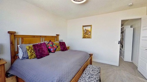 163 Sundown Crescent, Cochrane, AB - Indoor Photo Showing Bedroom