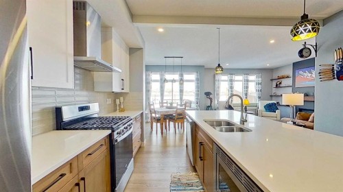 163 Sundown Crescent, Cochrane, AB - Indoor Photo Showing Kitchen With Double Sink With Upgraded Kitchen