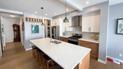 163 Sundown Crescent, Cochrane, AB - Indoor Photo Showing Kitchen With Double Sink With Upgraded Kitchen