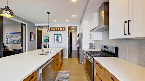 163 Sundown Crescent, Cochrane, AB - Indoor Photo Showing Kitchen With Double Sink With Upgraded Kitchen