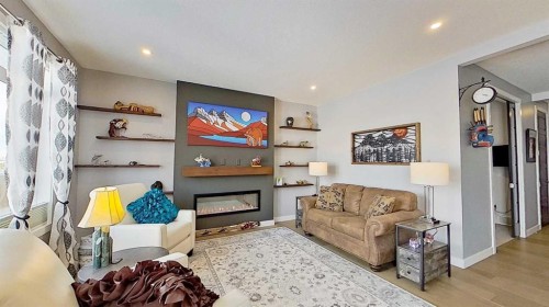 163 Sundown Crescent, Cochrane, AB - Indoor Photo Showing Other Room With Fireplace
