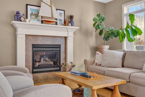 97 Strathridge Close Sw, Calgary, AB - Indoor Photo Showing Living Room With Fireplace