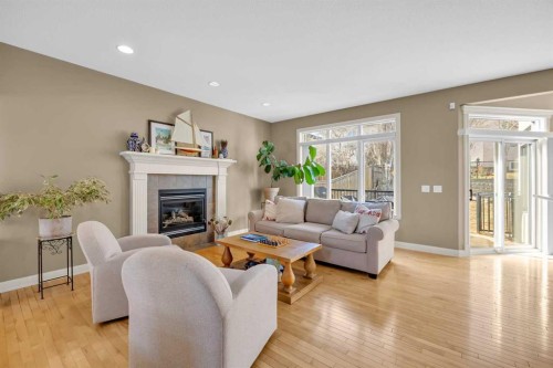 97 Strathridge Close Sw, Calgary, AB - Indoor Photo Showing Living Room With Fireplace