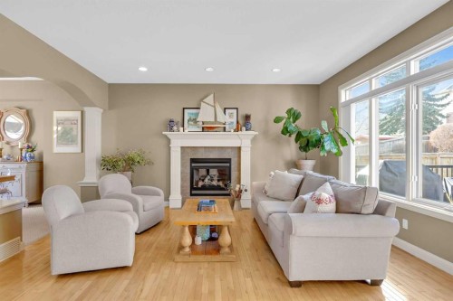 97 Strathridge Close Sw, Calgary, AB - Indoor Photo Showing Living Room With Fireplace