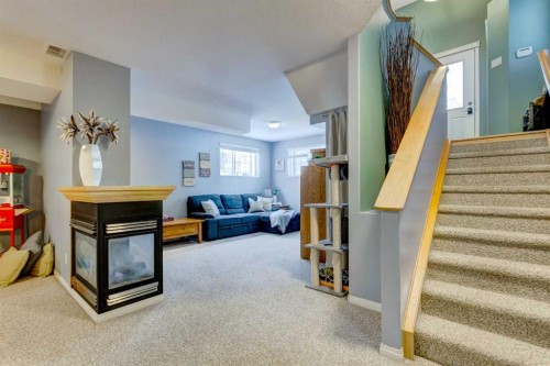 27 Elgin Drive Se, Calgary, AB - Indoor Photo Showing Other Room With Fireplace