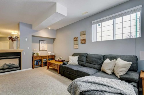 27 Elgin Drive Se, Calgary, AB - Indoor Photo Showing Living Room With Fireplace