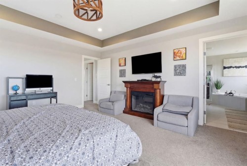 1469 Aldrich Place, Carstairs, AB - Indoor Photo Showing Bedroom With Fireplace
