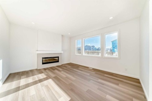 67 Creekside Path Sw, Calgary, AB - Indoor Photo Showing Living Room With Fireplace