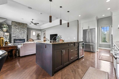22 Wendham Place Sw, Calgary, AB - Indoor Photo Showing Kitchen With Fireplace With Upgraded Kitchen