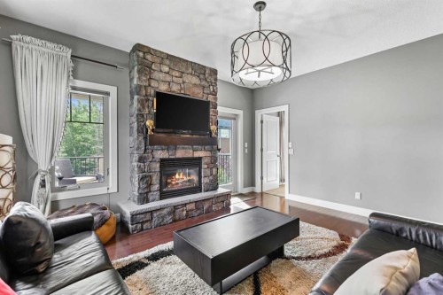 22 Wendham Place Sw, Calgary, AB - Indoor Photo Showing Living Room With Fireplace