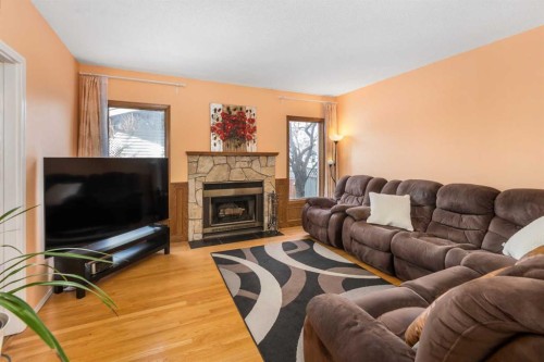 232 Millbank Drive Sw, Calgary, AB - Indoor Photo Showing Living Room With Fireplace
