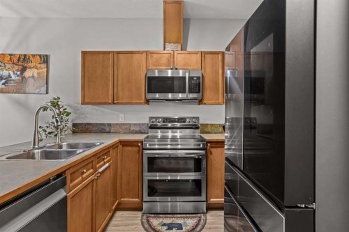 4-36 Windridge Road, Exshaw, AB - Indoor Photo Showing Kitchen With Double Sink
