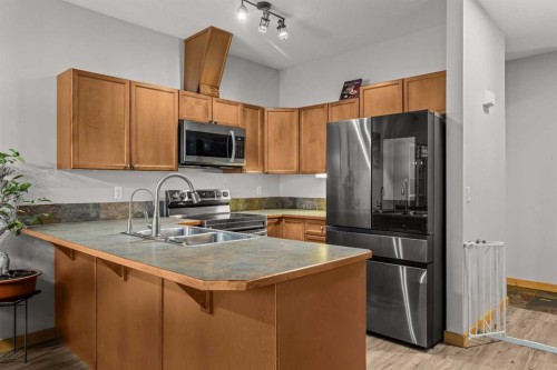 4-36 Windridge Road, Exshaw, AB - Indoor Photo Showing Kitchen With Stainless Steel Kitchen With Double Sink