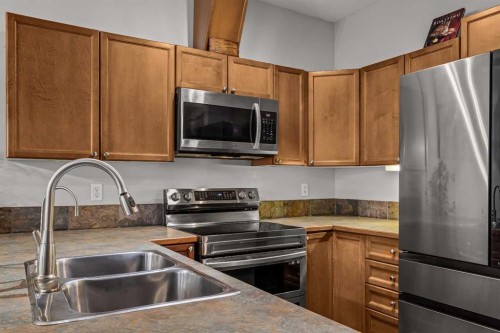 4-36 Windridge Road, Exshaw, AB - Indoor Photo Showing Kitchen With Stainless Steel Kitchen With Double Sink