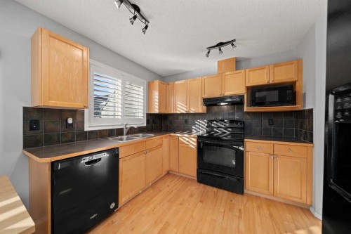 47 Eversyde Heath Sw, Calgary, AB - Indoor Photo Showing Kitchen With Double Sink