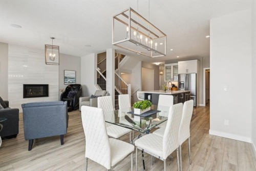415 Rivercrest Boulevard, Cochrane, AB - Indoor Photo Showing Dining Room With Fireplace