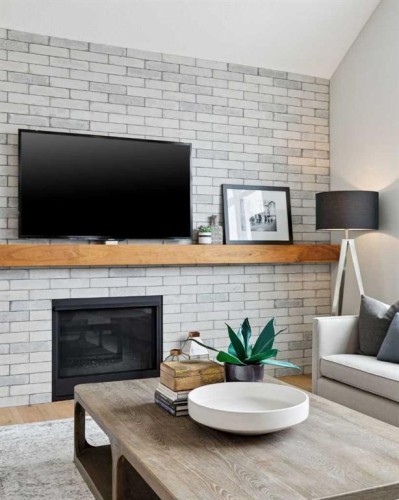 105 Masters Cape Se, Calgary, AB - Indoor Photo Showing Living Room With Fireplace