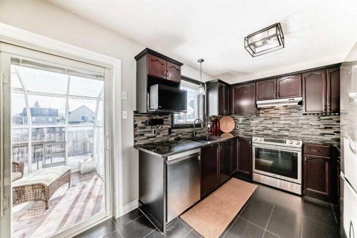 80 Hidden Point Nw, Calgary, AB - Indoor Photo Showing Kitchen With Double Sink With Upgraded Kitchen