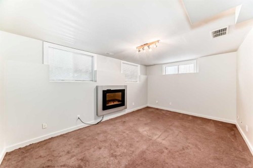 80 Hidden Point Nw, Calgary, AB - Indoor Photo Showing Other Room With Fireplace