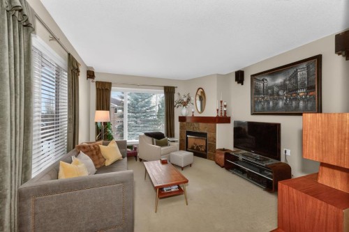 2735 Evercreek Bluffs Way Sw, Calgary, AB - Indoor Photo Showing Living Room With Fireplace