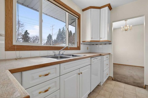 58 Westwood Drive Sw, Calgary, AB - Indoor Photo Showing Kitchen With Double Sink