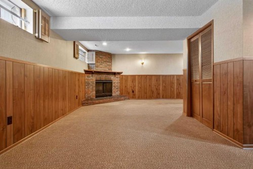 58 Westwood Drive Sw, Calgary, AB - Indoor Photo Showing Other Room With Fireplace