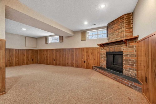 58 Westwood Drive Sw, Calgary, AB - Indoor Photo Showing Basement With Fireplace