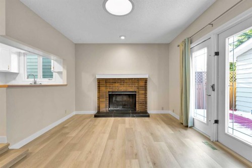 1111 Berkley Drive Nw, Calgary, AB - Indoor Photo Showing Living Room With Fireplace