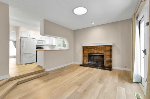 1111 Berkley Drive Nw, Calgary, AB - Indoor Photo Showing Living Room With Fireplace