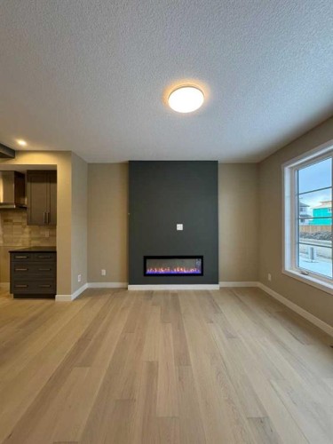 275 Waterford Heights, Chestermere, AB - Indoor Photo Showing Other Room With Fireplace